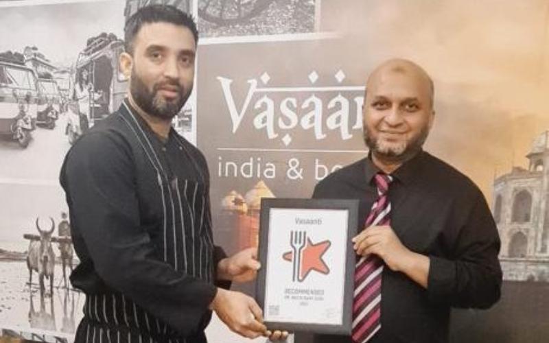 Enam Ahmed, chef, and Akbar Miah, manager holding the award